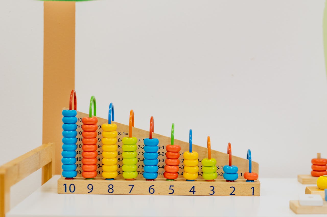 portfolio-01 Close-up of a colorful wooden counting toy with numbers and shapes, perfect for preschool learning.
